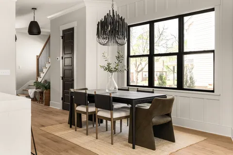 a dining room with furniture and window