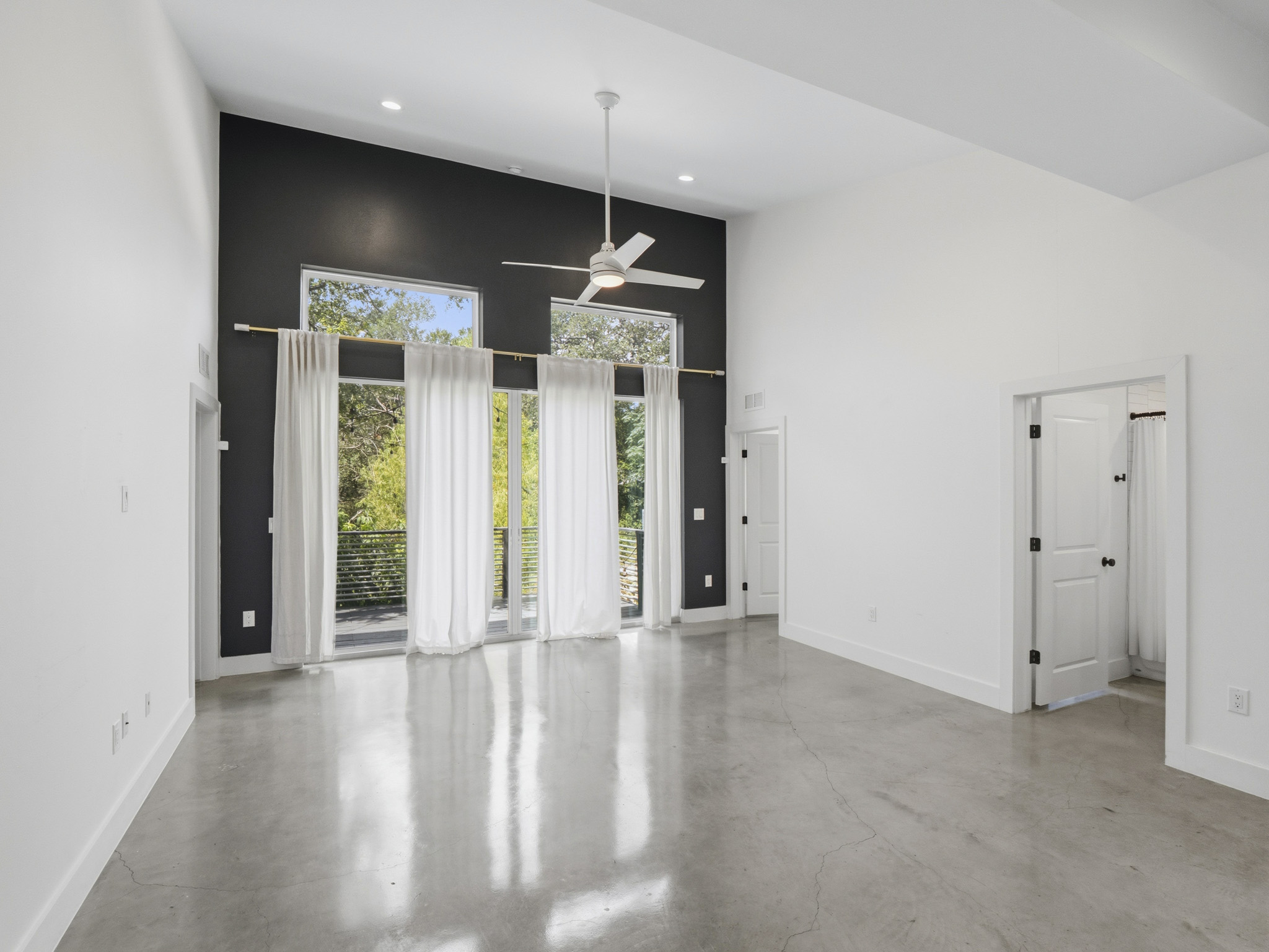 5005 Lott Avenue, Unit 2 Austin, TX 78721 - Photo 7 of 25 A generous room featuring soaring ceilings and polished concrete floors.