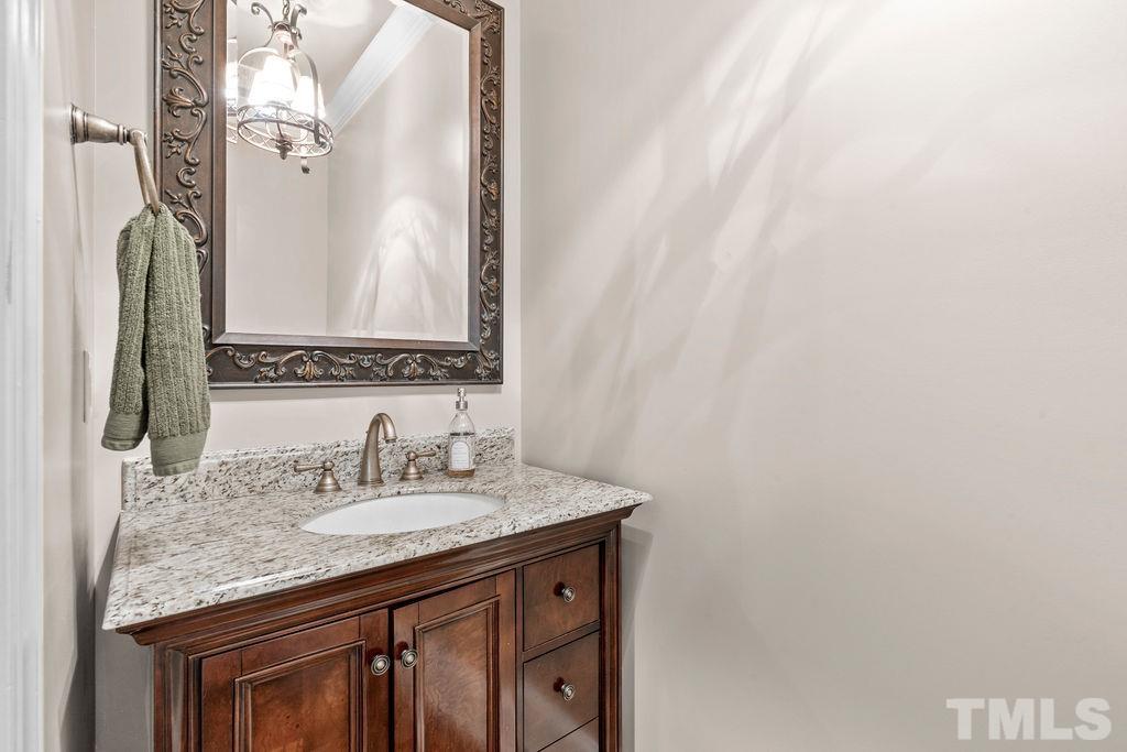 2325 Finley Ridge Lane Raleigh, NC 27615 - Photo 12 of 30 a bathroom with a granite countertop sink and a mirror