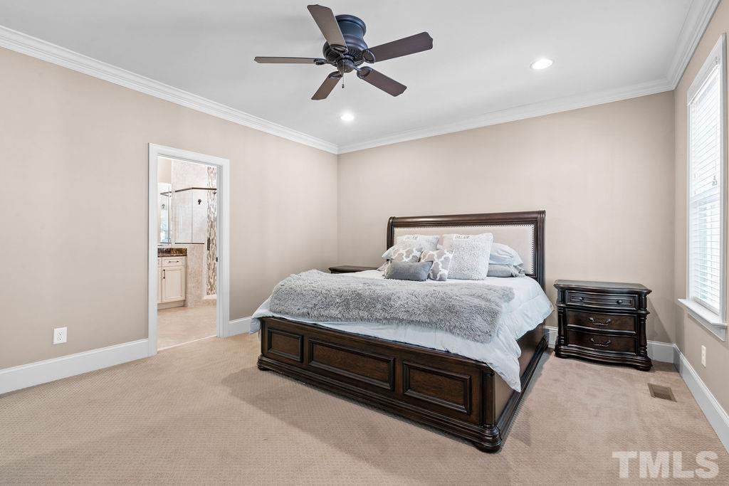 2325 Finley Ridge Lane Raleigh, NC 27615 - Photo 14 of 30 a spacious bedroom with a bed and a ceiling fan