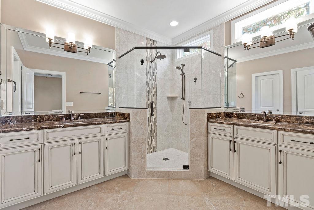 2325 Finley Ridge Lane Raleigh, NC 27615 - Photo 16 of 30 a spacious bathroom with a shower sink double and mirror
