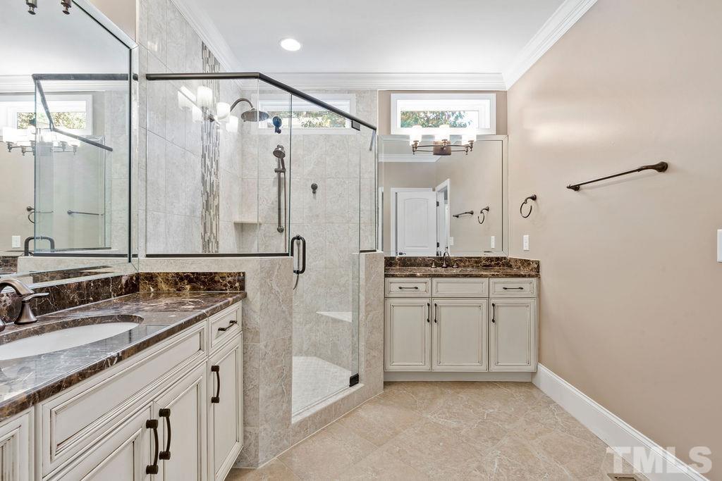 2325 Finley Ridge Lane Raleigh, NC 27615 - Photo 17 of 30 a bathroom with a granite countertop sink a mirror a shower and a mirror
