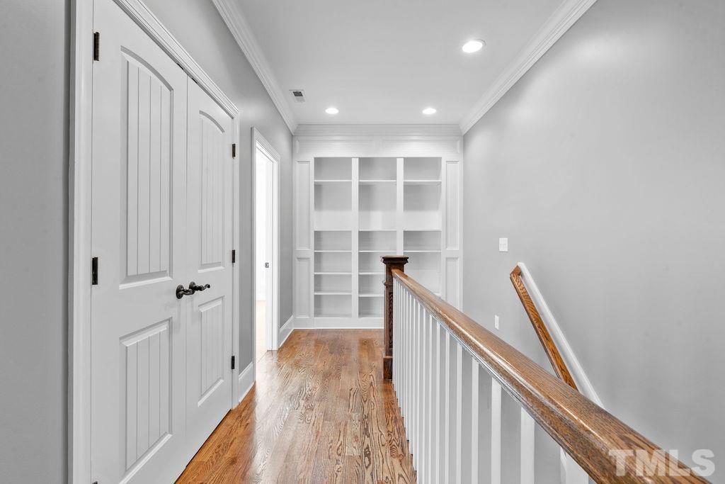 2325 Finley Ridge Lane Raleigh, NC 27615 - Photo 18 of 30 a view of a hallway with wooden floor and staircase