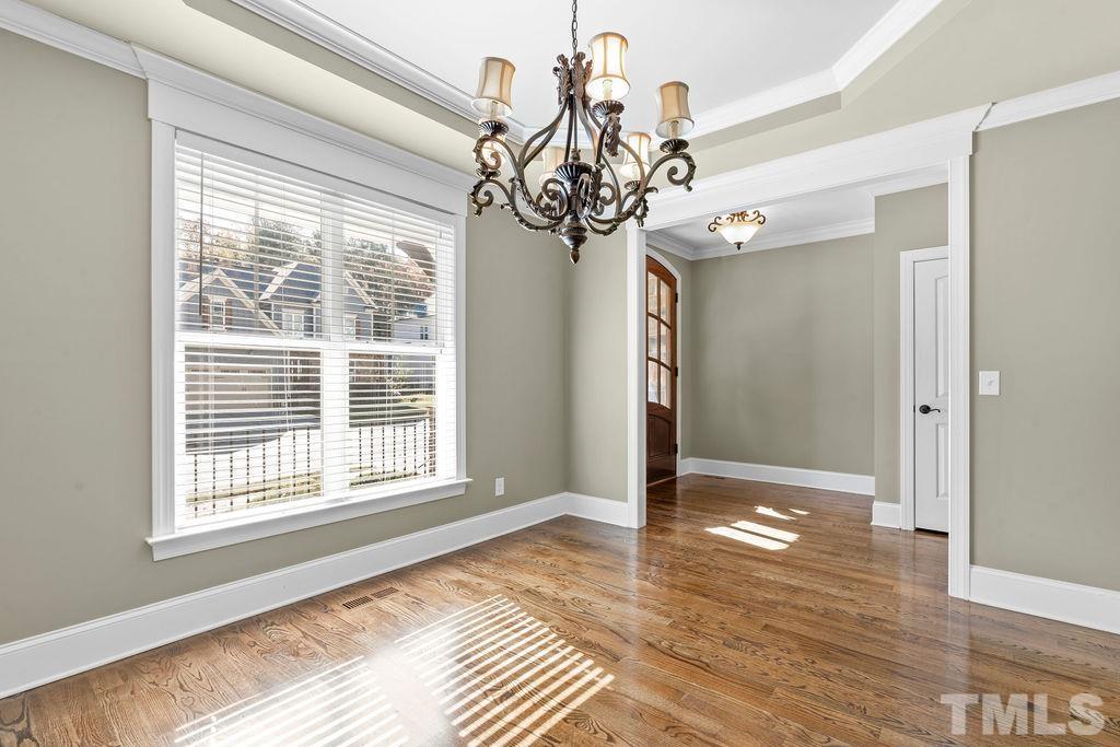 2325 Finley Ridge Lane Raleigh, NC 27615 - Photo 4 of 30 a view of an empty room with wooden floor and a window