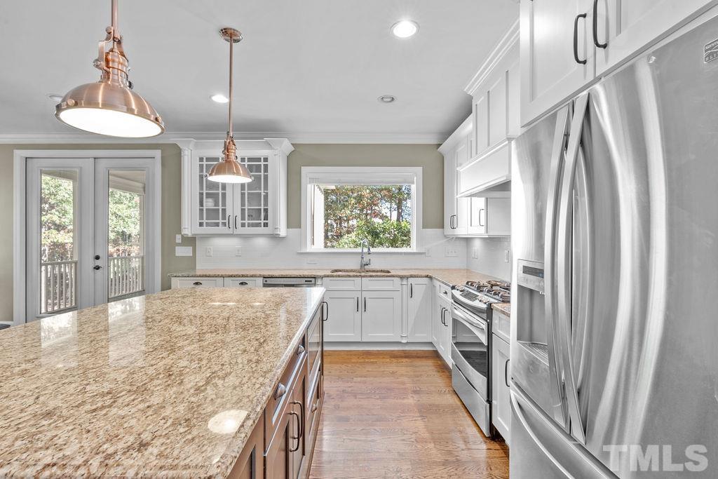 2325 Finley Ridge Lane Raleigh, NC 27615 - Photo 6 of 30 a large kitchen with cabinets and wooden floor