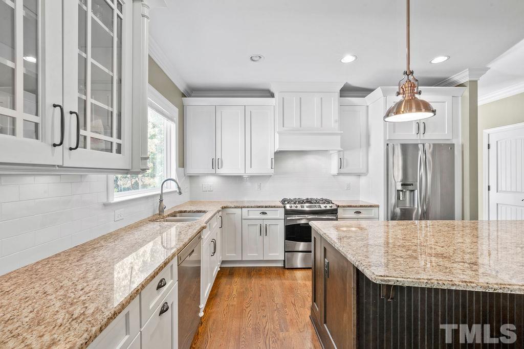 2325 Finley Ridge Lane Raleigh, NC 27615 - Photo 8 of 30 a kitchen with a stove sink and cabinets