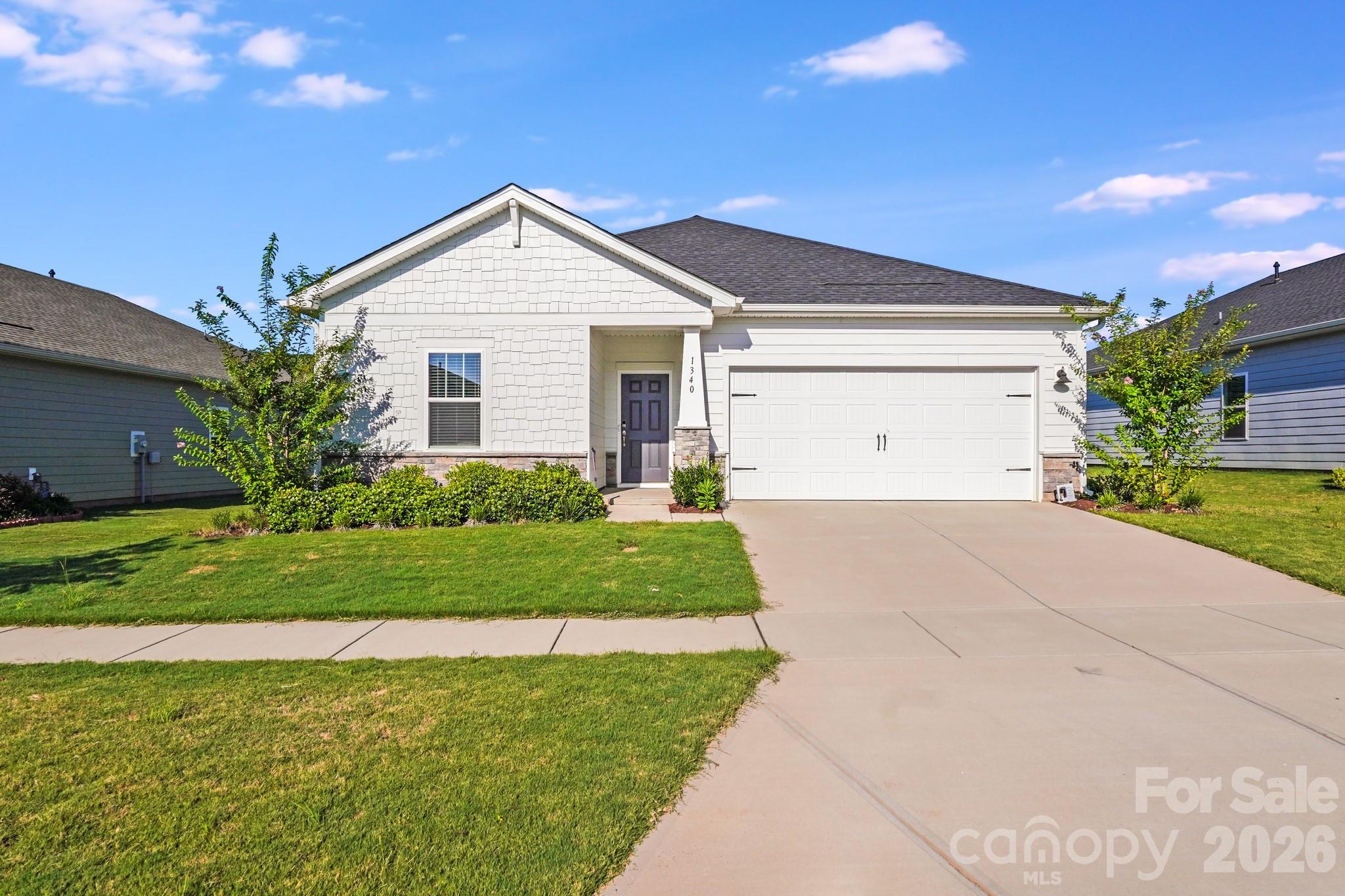 a view of a house with a yard and plants