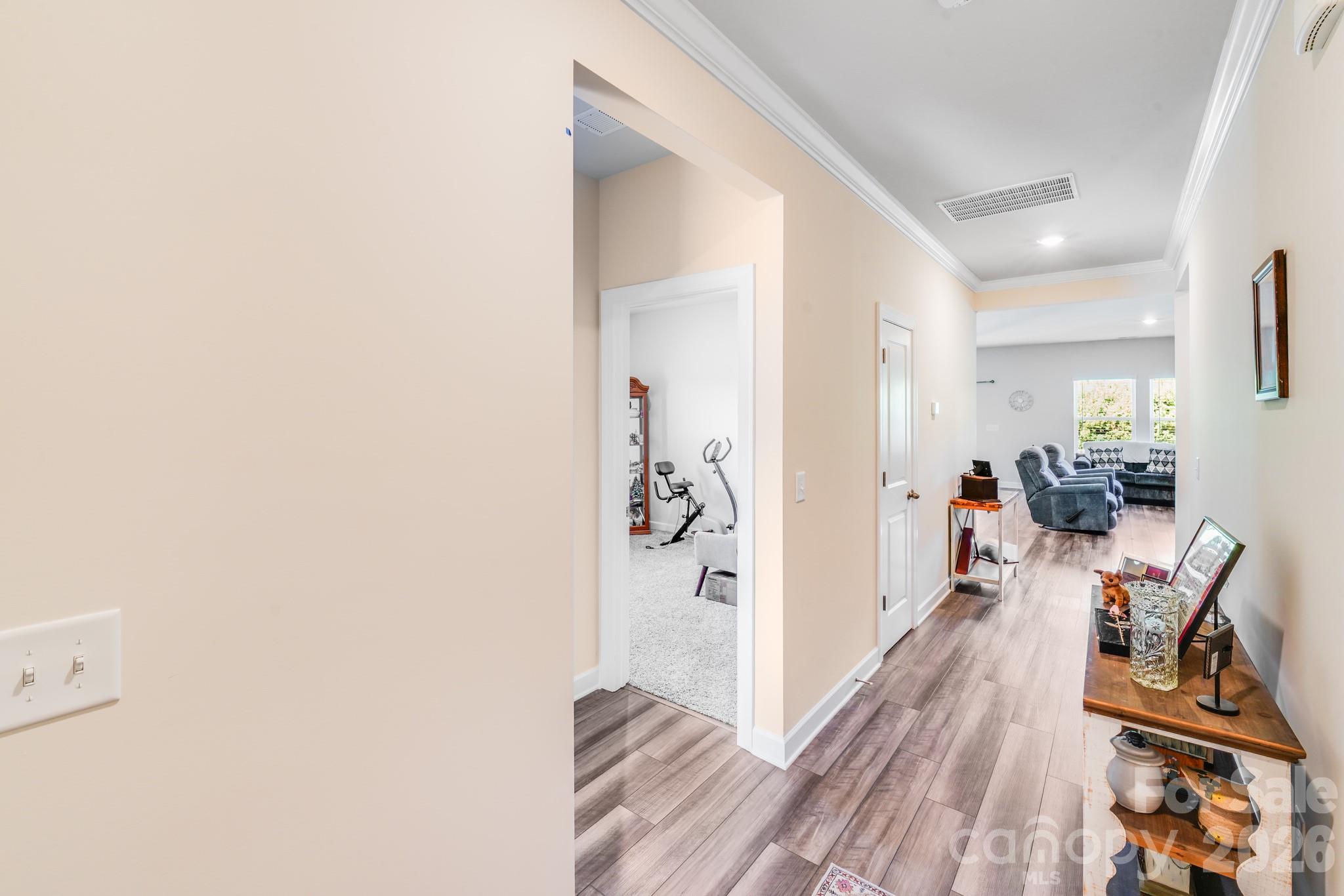 1340 Sweet Pea Street Monroe, NC 28110 - Photo 16 of 32 a view of a hallway with wooden floor and a living room