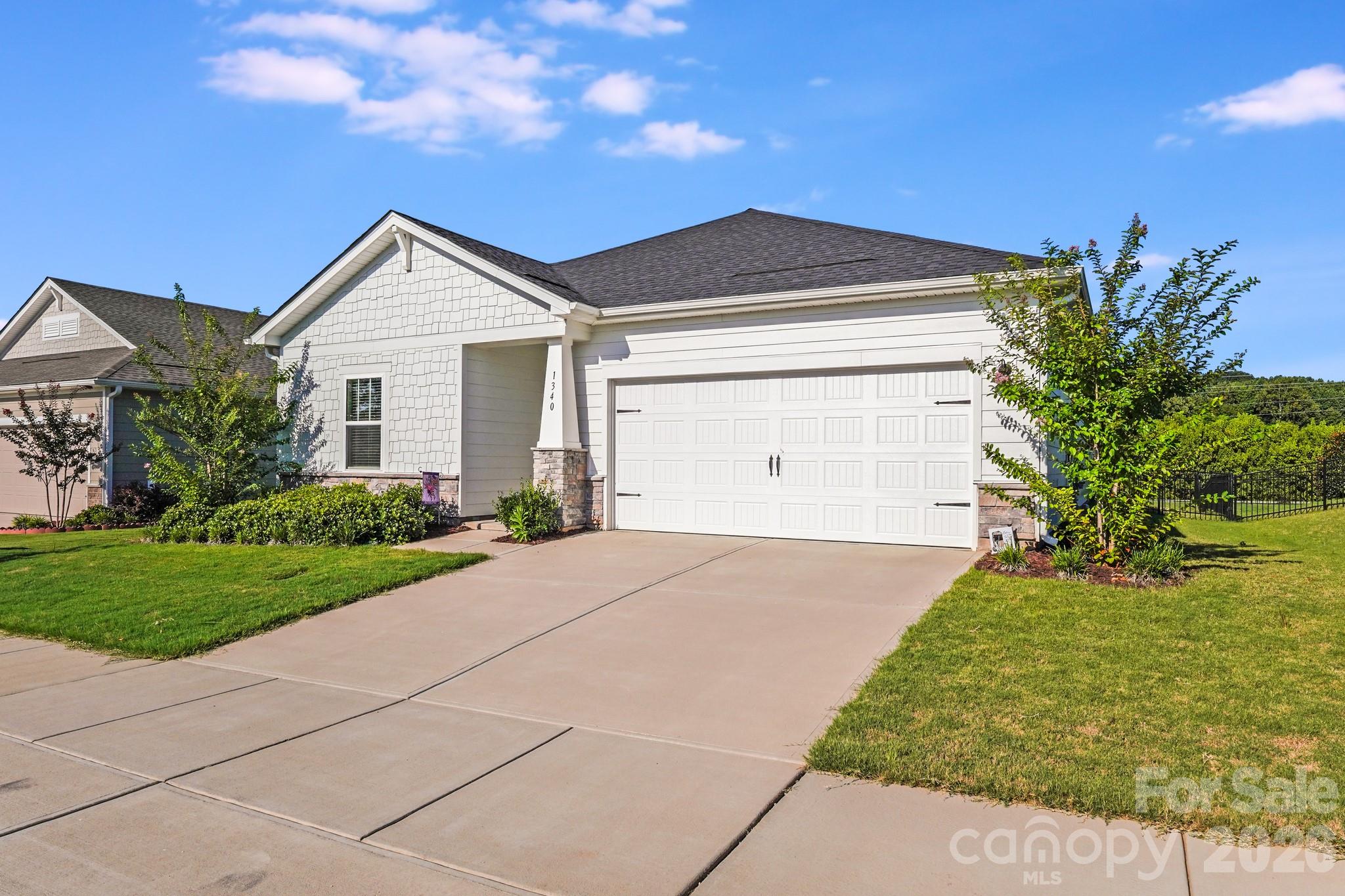 1340 Sweet Pea Street Monroe, NC 28110 - Photo 2 of 32 a front view of a house with a yard and garage