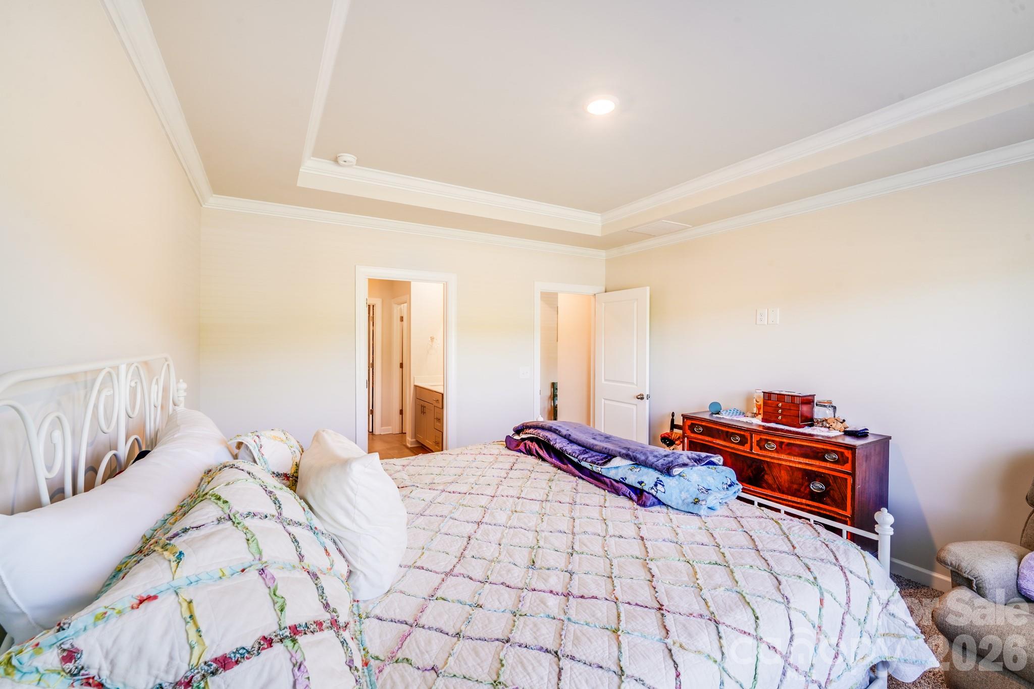 1340 Sweet Pea Street Monroe, NC 28110 - Photo 22 of 32 a bedroom with a bed and a lamp