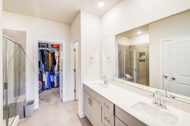 a bathroom with a double vanity sink and a mirror
