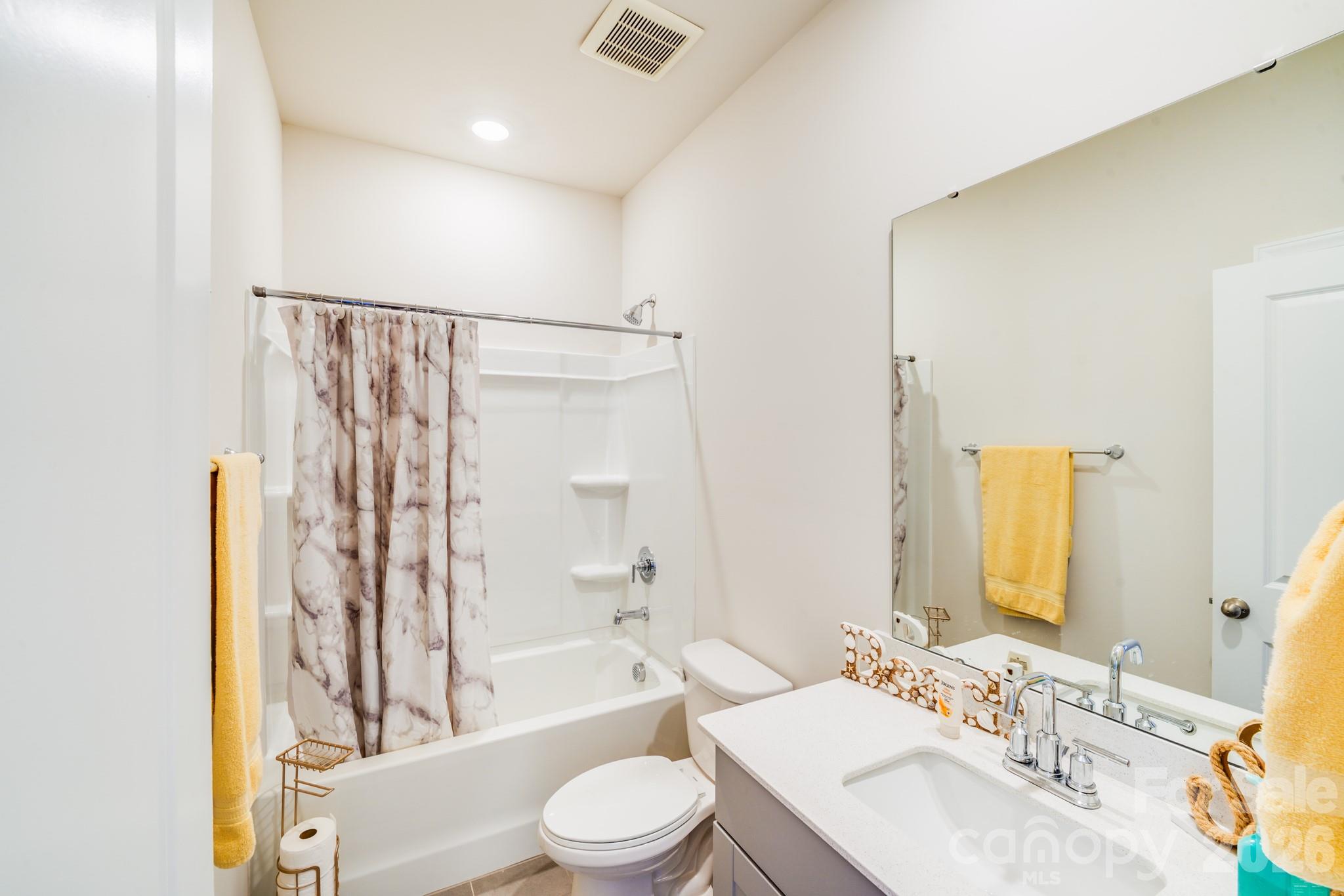 1340 Sweet Pea Street Monroe, NC 28110 - Photo 25 of 32 a bathroom with a bathtub shower sink vanity mirror and toilet