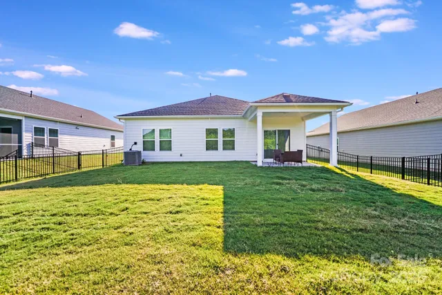 a view of a house with backyard and a patio
