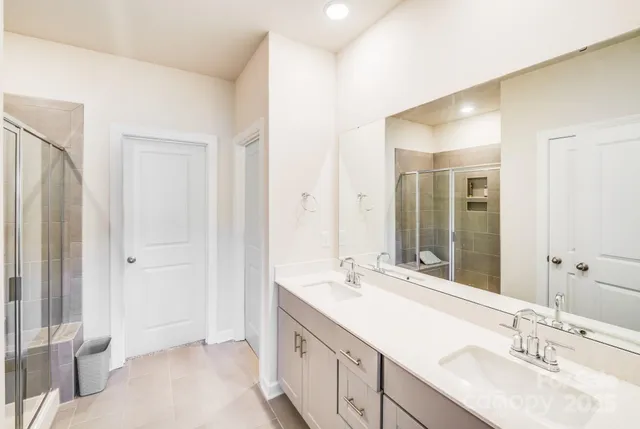 a bathroom with a double vanity sink and a mirror