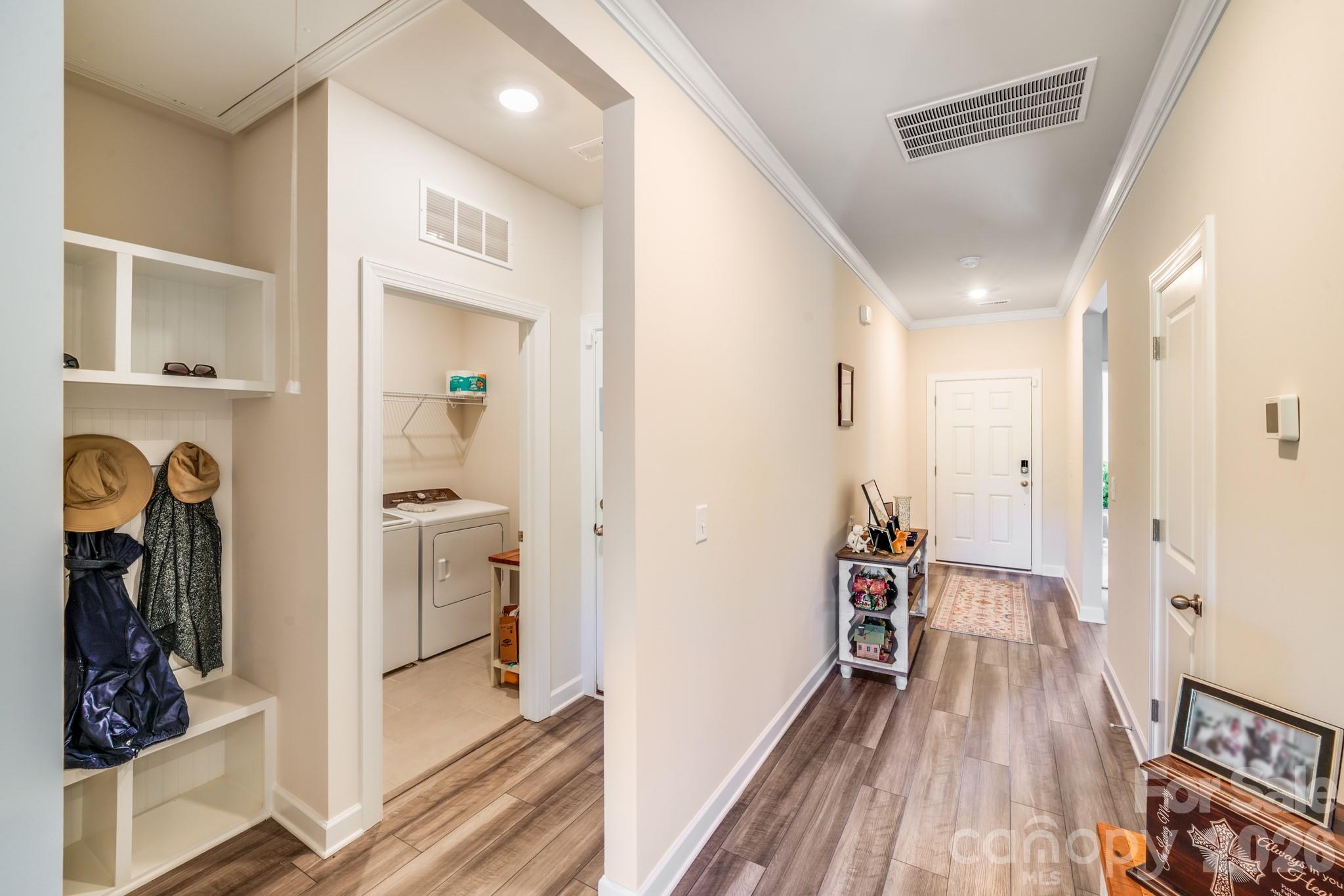 1340 Sweet Pea Street Monroe, NC 28110 - Photo 8 of 32 a view of a hallway with wooden floor and closet