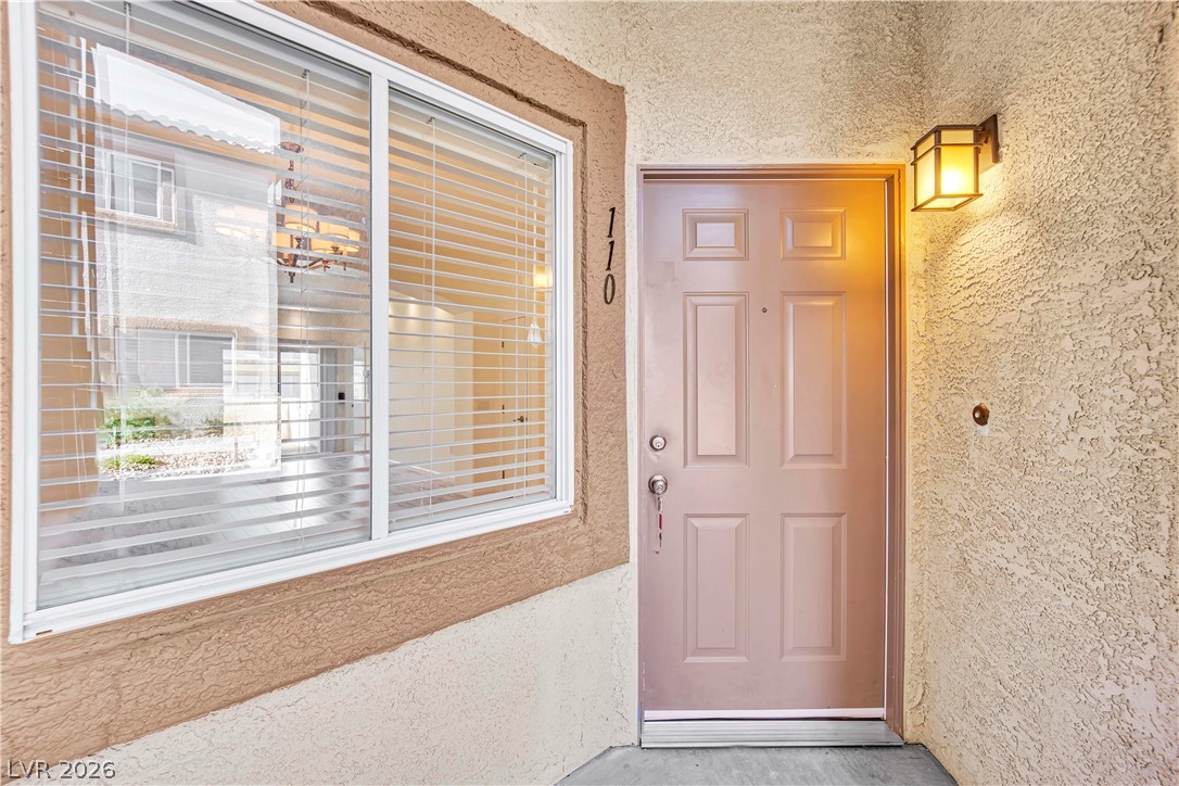 8725 West Flamingo Road, Unit 110 Las Vegas, NV 89147 - Photo 19 of 30 Secure entry point with a well-lit doorway and inviting natural light.