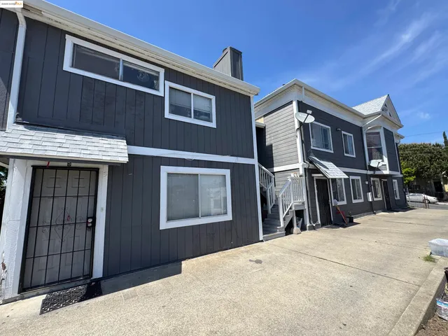 a view of a house with a wooden fence
