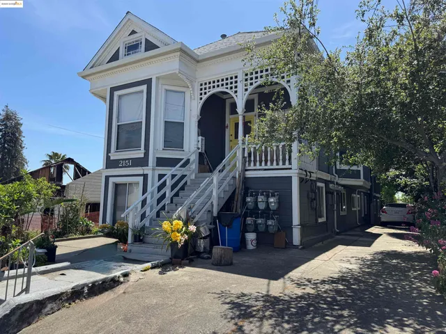 a front view of house with a garden