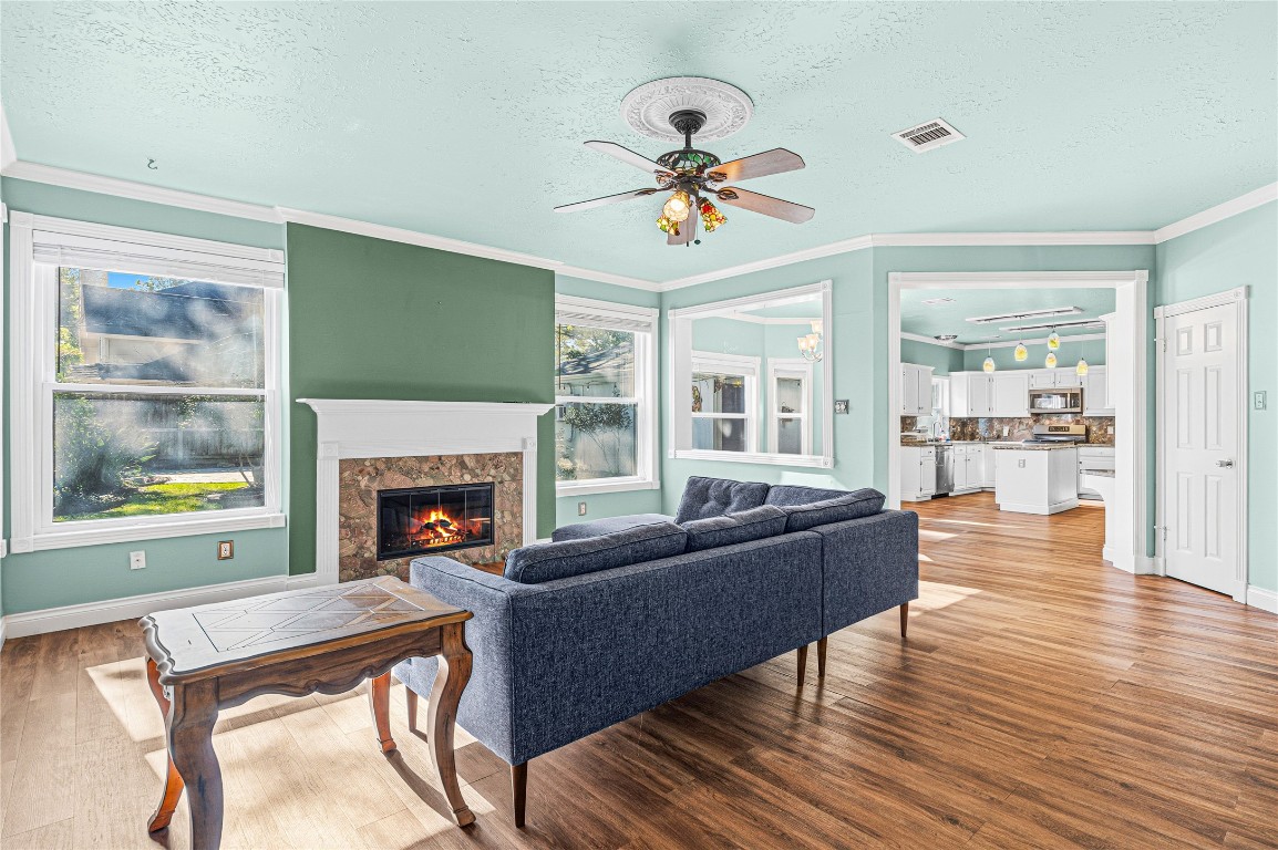 7906 Duncansby Vale Road Houston, TX 77095 - Photo 15 of 48 Spacious living area with a cozy fireplace and views of the backyard.