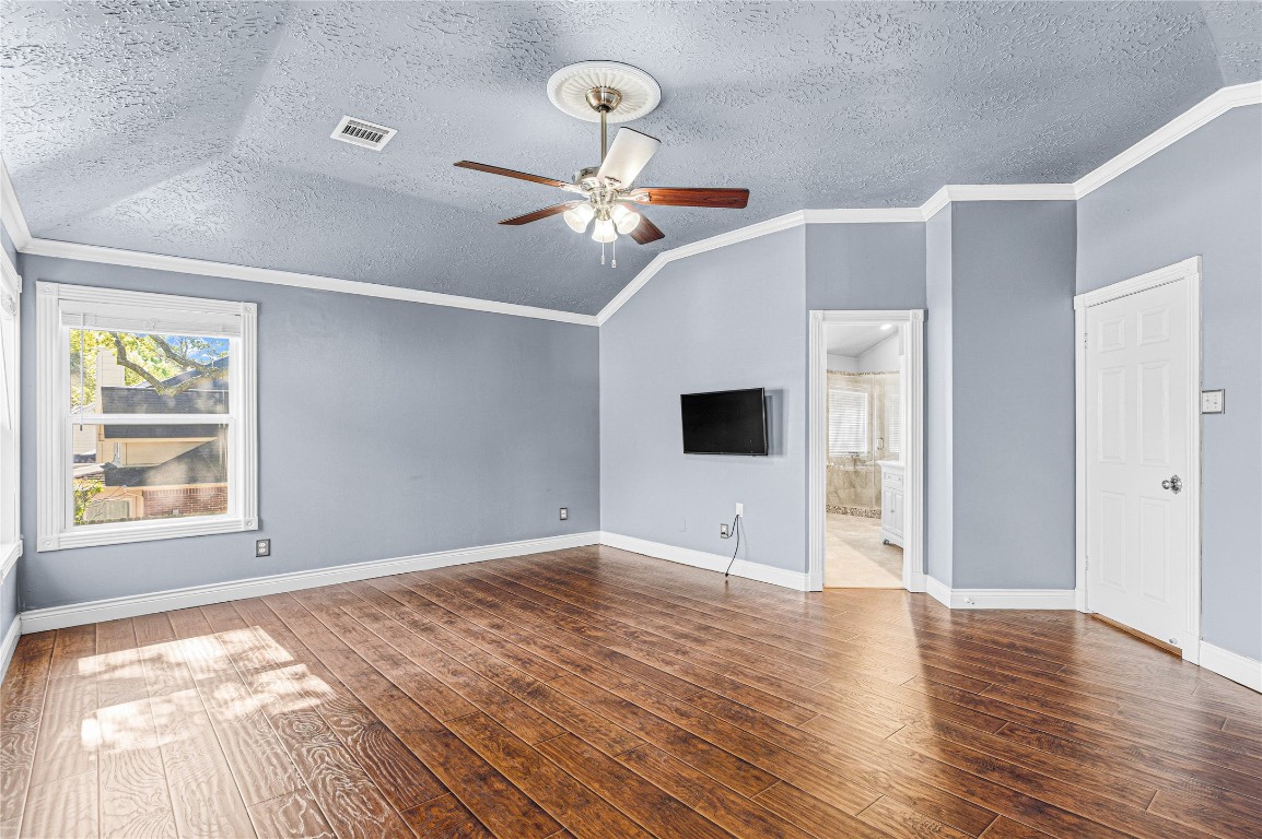 7906 Duncansby Vale Road Houston, TX 77095 - Photo 27 of 48 Generously sized primary bedroom has vaulted ceilings and abundant natural light.