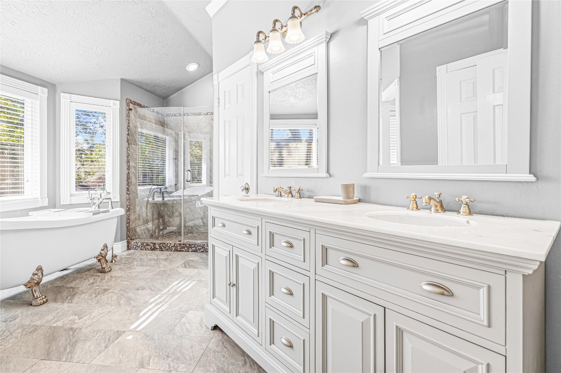 7906 Duncansby Vale Road Houston, TX 77095 - Photo 29 of 48 Spa-inspired primary bath featuring dual vanities, a soaking tub, and separate shower.