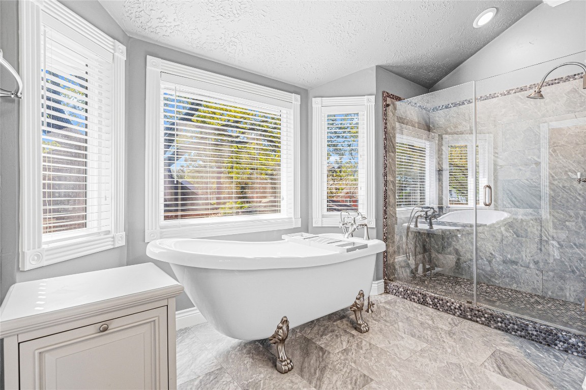 7906 Duncansby Vale Road Houston, TX 77095 - Photo 30 of 48 Freestanding soaking tub set beneath natural light for a relaxing, retreat-like feel.