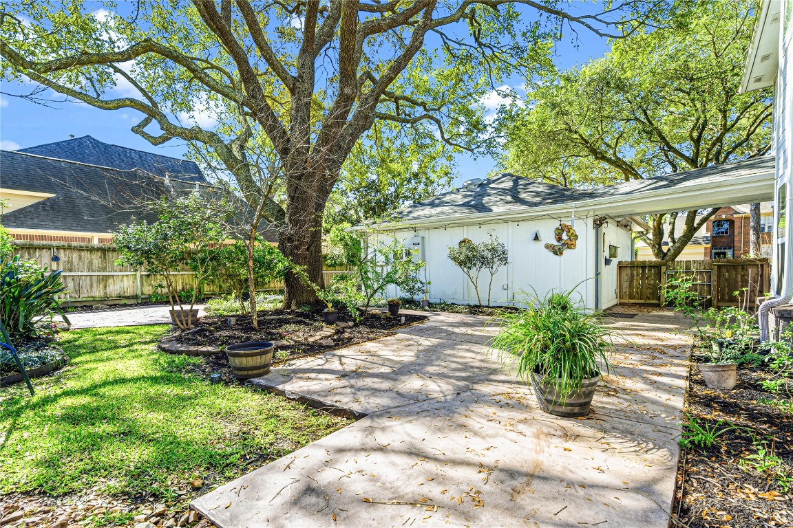 7906 Duncansby Vale Road Houston, TX 77095 - Photo 3 of 48 Expansive backyard framed by mature trees and thoughtfully designed landscaping. The backyard has landscape that blooms year-round. The Spring bloom is ready to start now. Also included are fruit bearing trees: peach, Mexican plum and Chickasaw plum
