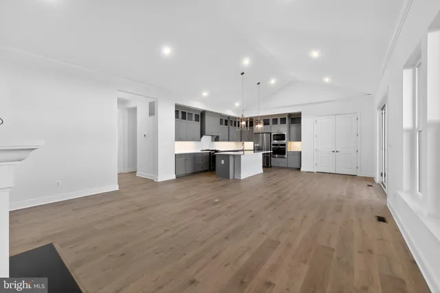 a view of kitchen with refrigerator and window