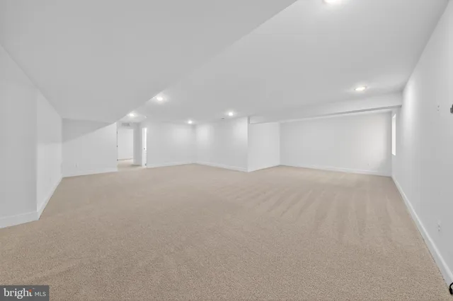 a view of a big room with wooden floor and windows