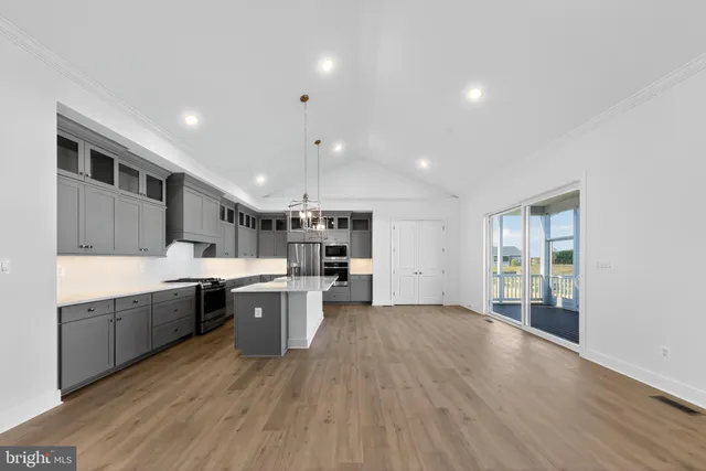 a large kitchen with a table and chairs in it