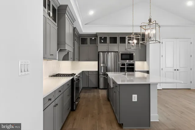 a kitchen with stainless steel appliances granite countertop a stove and a refrigerator