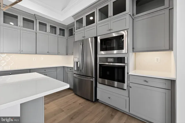 a kitchen with stainless steel appliances a stove microwave and refrigerator