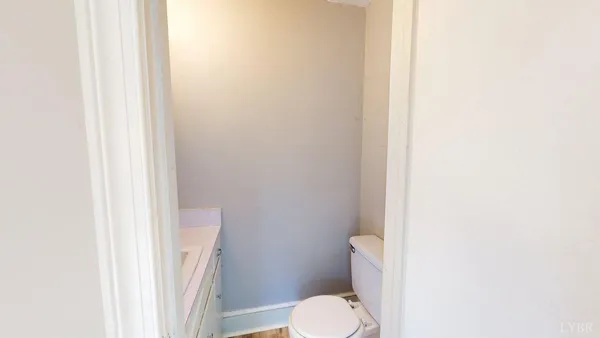 a white toilet sitting next to a shower