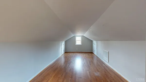 a view of wooden floor and windows in an empty room