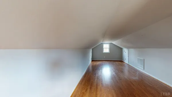 a view of an empty room and wooden floor