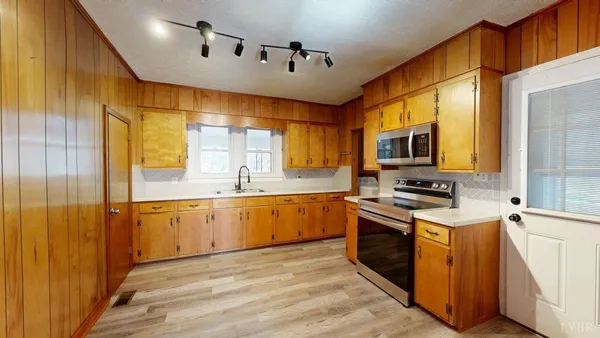 a kitchen with stainless steel appliances granite countertop a stove and a sink