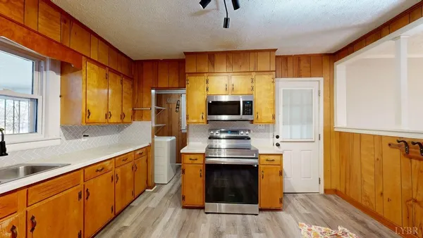 a kitchen with stainless steel appliances a stove a refrigerator and a sink