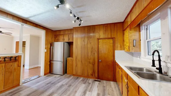 a kitchen with stainless steel appliances granite countertop a refrigerator and a sink