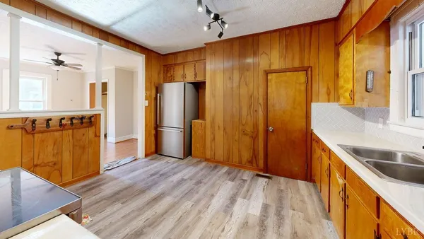 a view of a kitchen with wooden floor and staircase