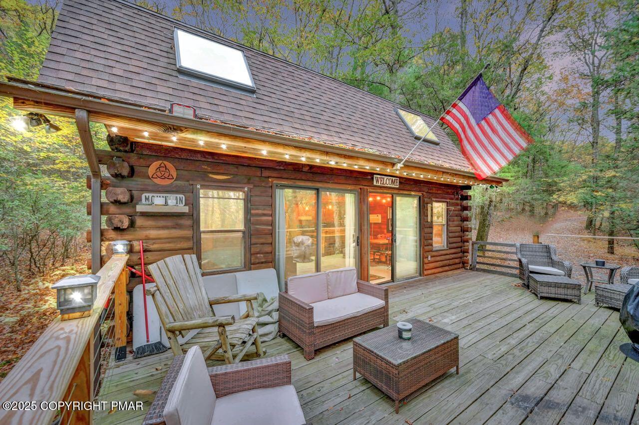 a view of a deck with couches and wooden floor