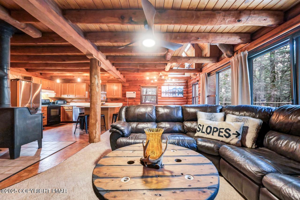 185 Whispering Pine Road Kunkletown, PA 18058 - Photo 13 of 65 a living room with lots of furniture and a chandelier