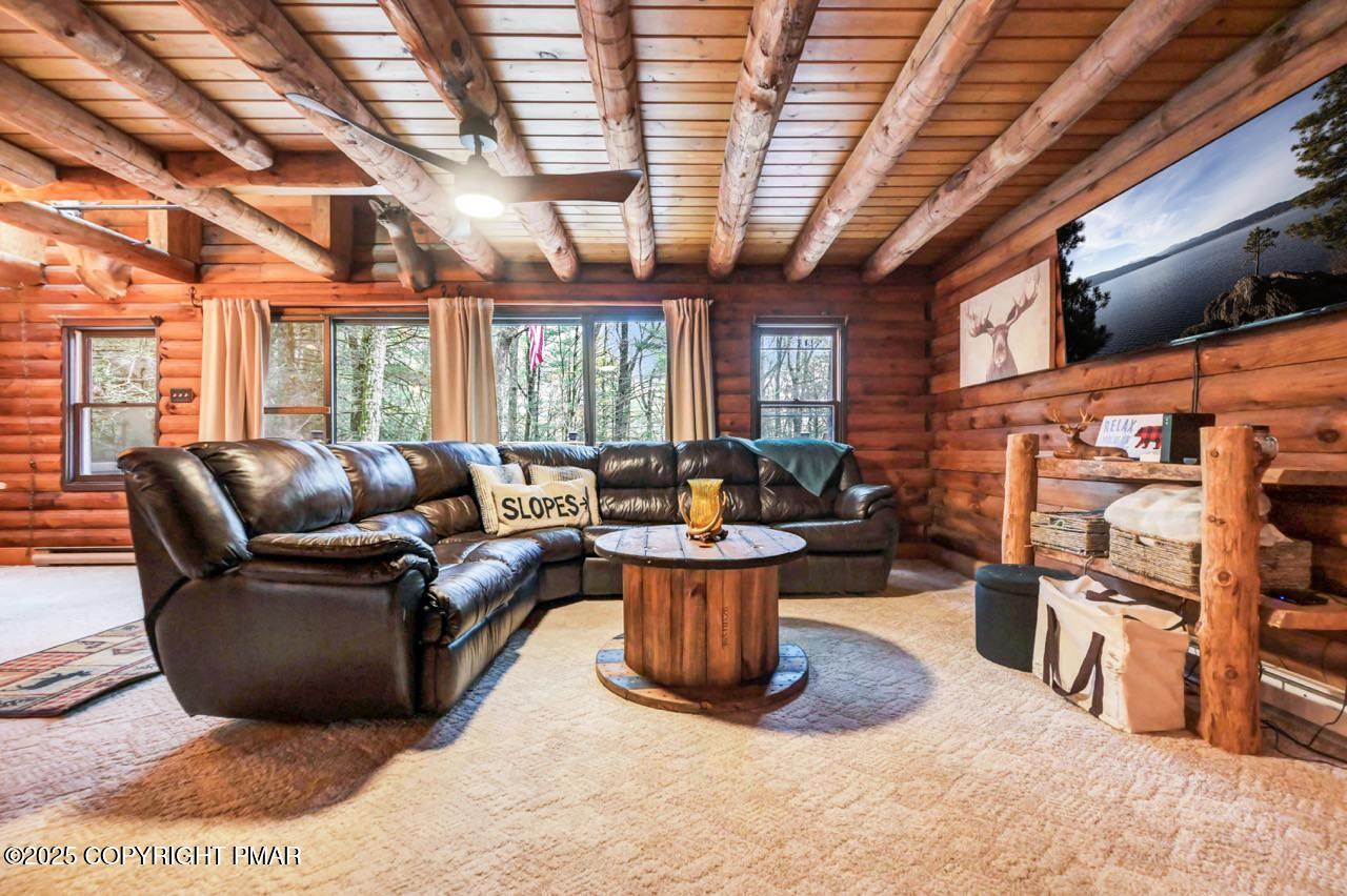 185 Whispering Pine Road Kunkletown, PA 18058 - Photo 14 of 65 a living room with furniture a flat screen tv and potted plant