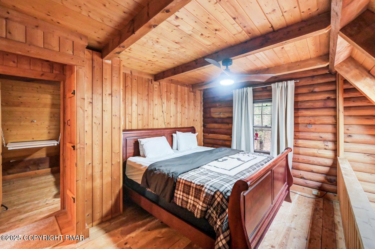 185 Whispering Pine Road Kunkletown, PA 18058 - Photo 29 of 65 a bedroom with a bed and a night stand