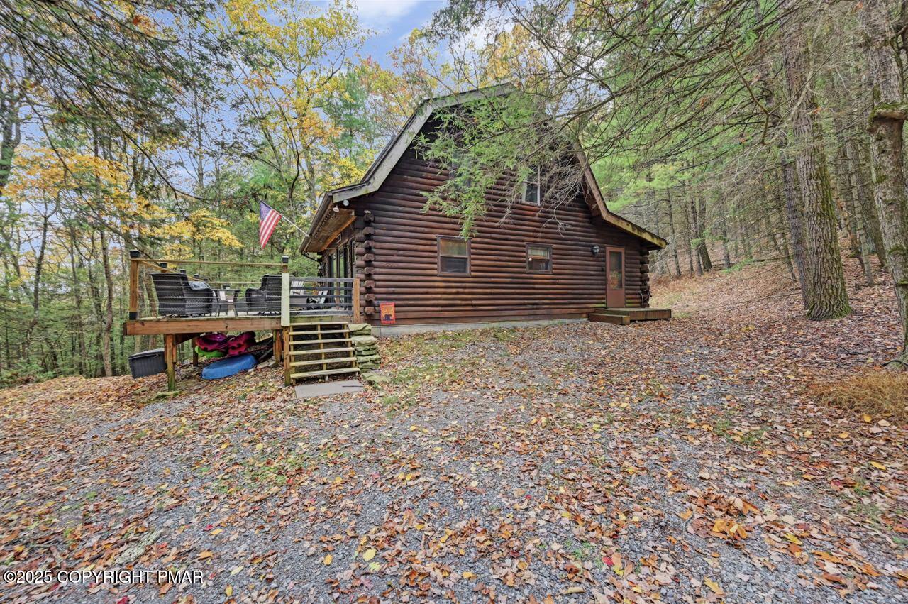 185 Whispering Pine Road Kunkletown, PA 18058 - Photo 48 of 65 a view of backyard with wooden fence and large trees