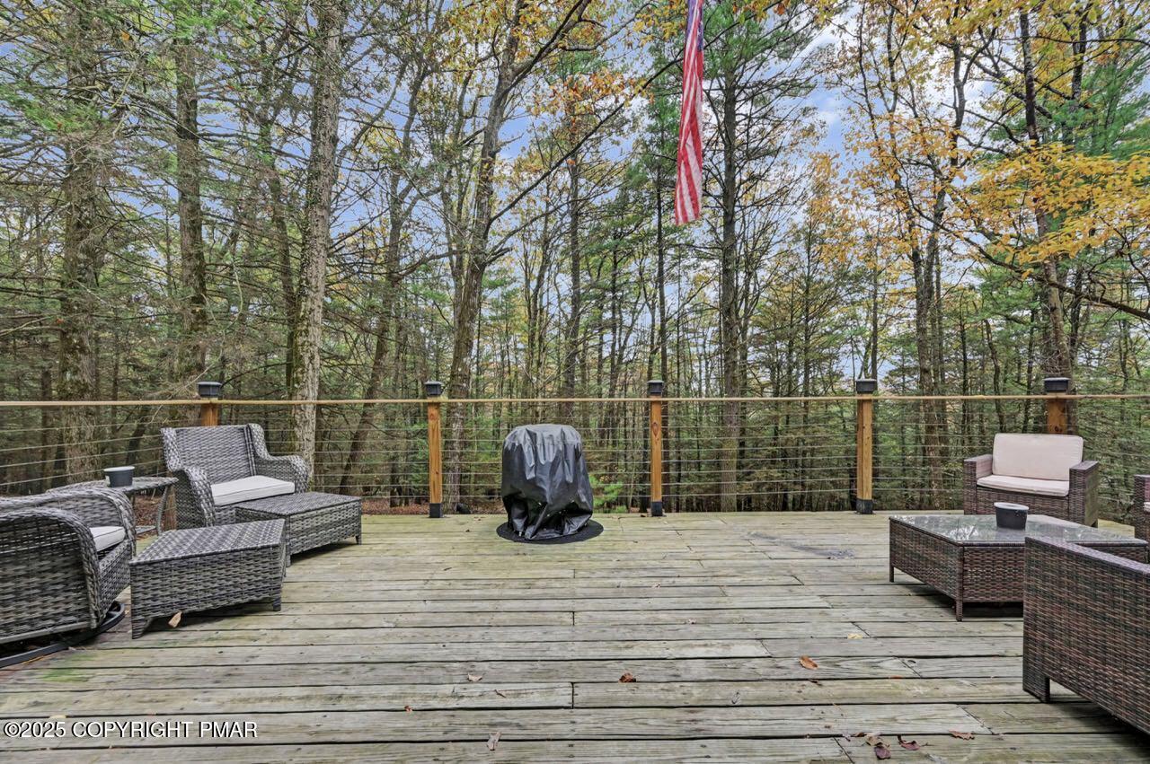 185 Whispering Pine Road Kunkletown, PA 18058 - Photo 52 of 65 a roof deck with couches and wooden floor