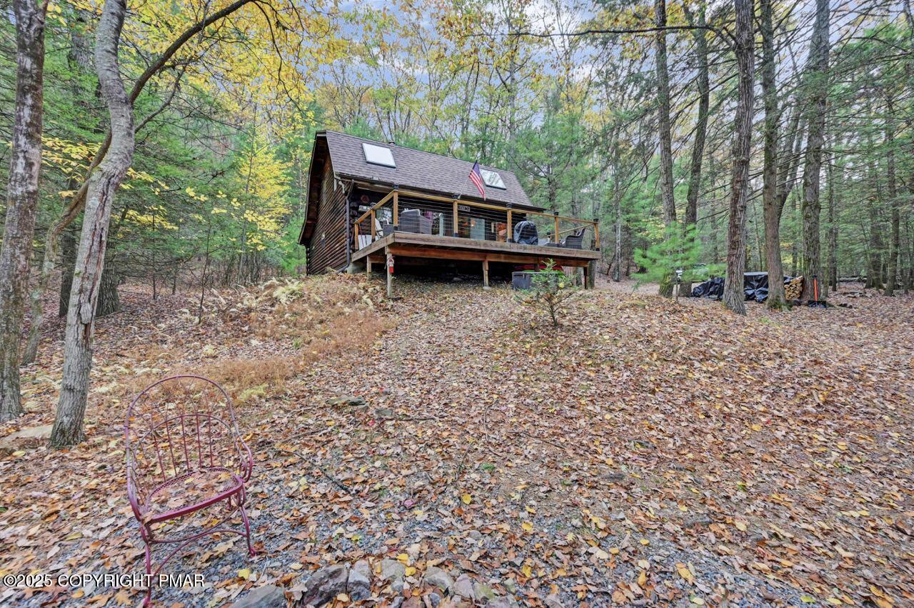 185 Whispering Pine Road Kunkletown, PA 18058 - Photo 55 of 65 a backyard of a house with table and chairs