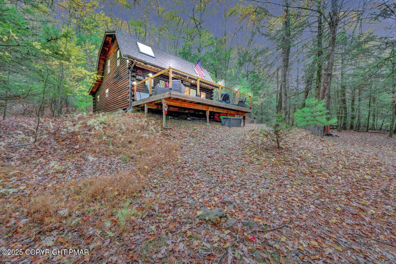 185 Whispering Pine Road Kunkletown, PA 18058 - Photo 56 of 65 a backyard of a house with table and chairs