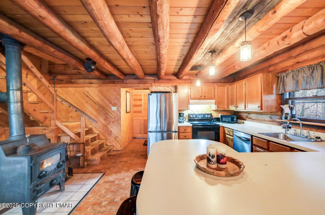 185 Whispering Pine Road Kunkletown, PA 18058 - Photo 62 of 65 a kitchen with stainless steel appliances kitchen island granite countertop a sink and cabinets