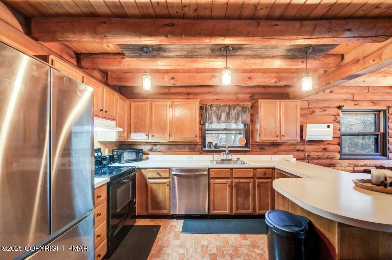185 Whispering Pine Road Kunkletown, PA 18058 - Photo 7 of 65 a kitchen with stainless steel appliances granite countertop a sink a stove and refrigerator