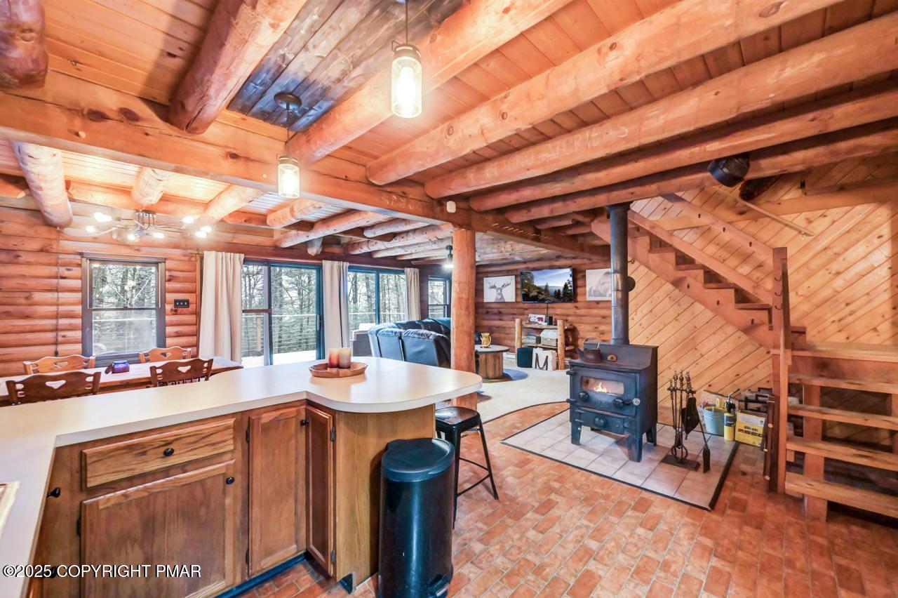 185 Whispering Pine Road Kunkletown, PA 18058 - Photo 9 of 65 a outdoor space with the couches and dining table and chairs with wooden floor
